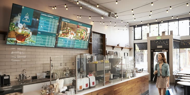 Modern café with digital signage screens displaying digital menu boards