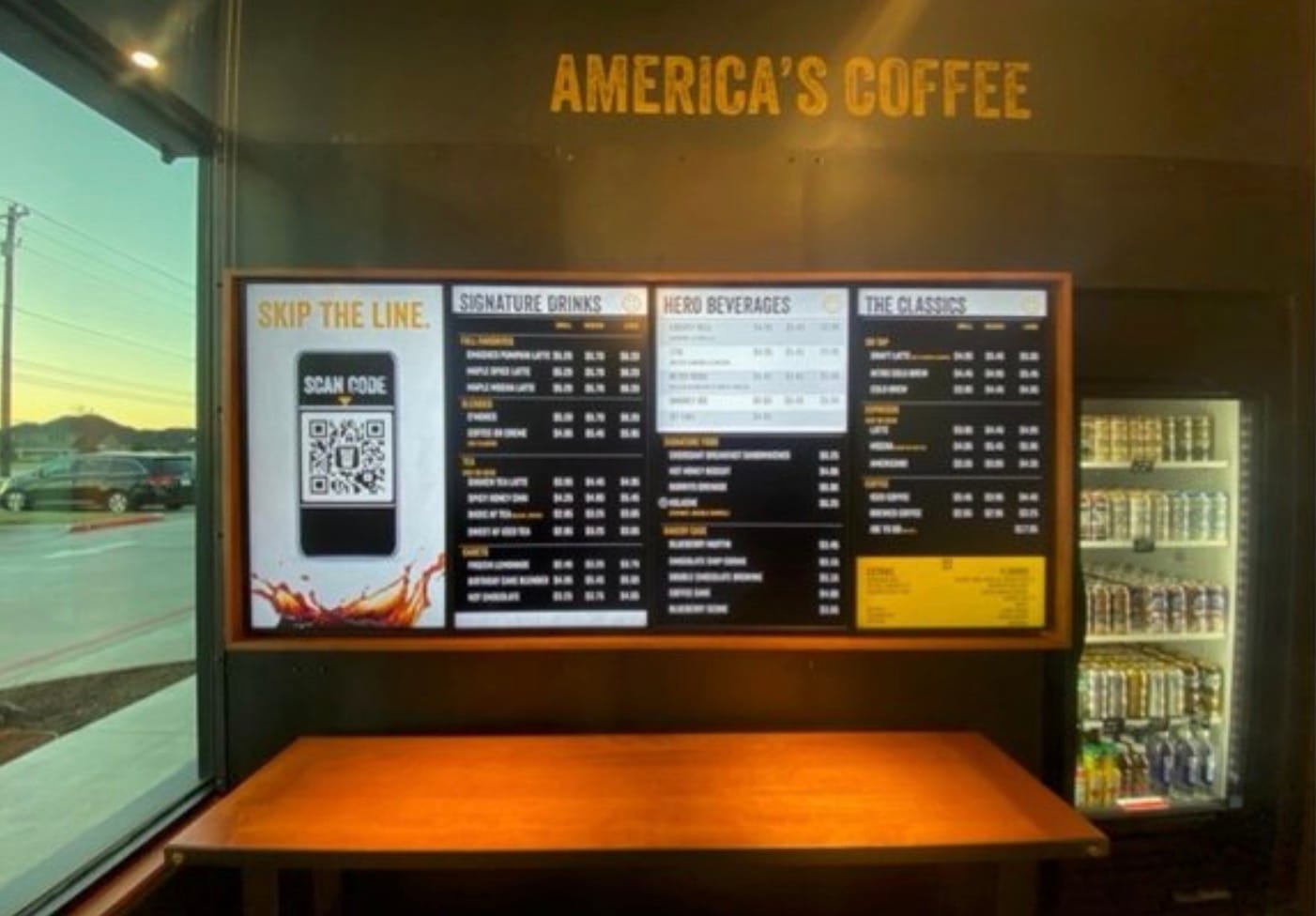 Digital menu board showcasing in-store digital marketing at a coffee shop